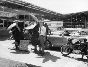 Dick Baker in front of the old Chehalis store with Yard Birds and a motorcycle.