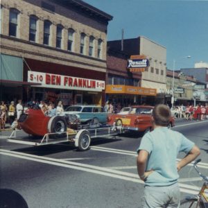 The Yard Birds sponsored dragster being towed on a trailer during a parade in Centralia, WA